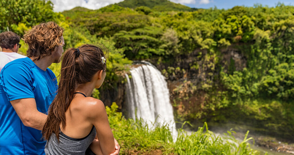 Couple tourists at Hawaii waterfall