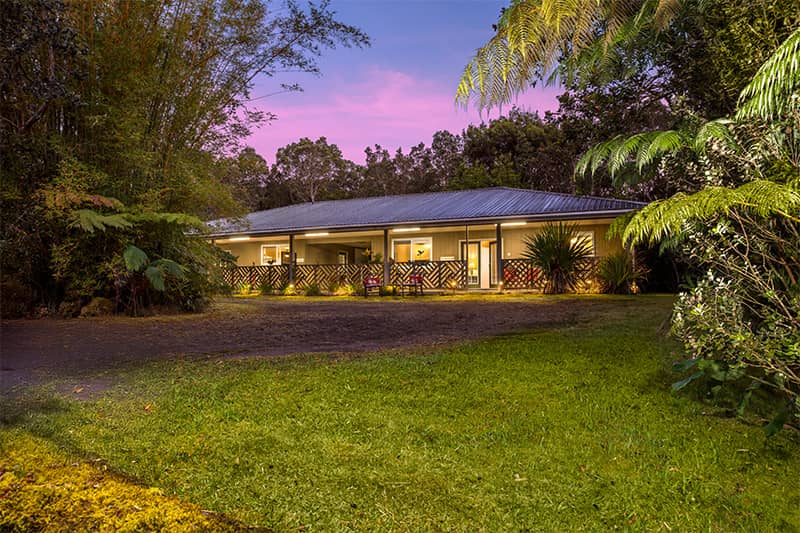 5th Street Ohana vacation rental in Volcano front of the house with a pretty sunset in the background