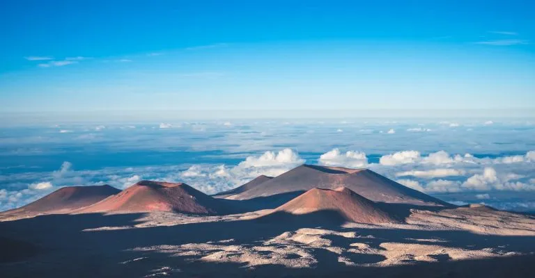 Volcanic cones above the cloud layer on the high-altitude slopes of Mauna Kea on the Big Island of Hawaii